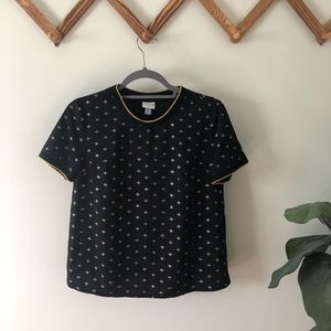 a new day, black and gold short sleeve top.